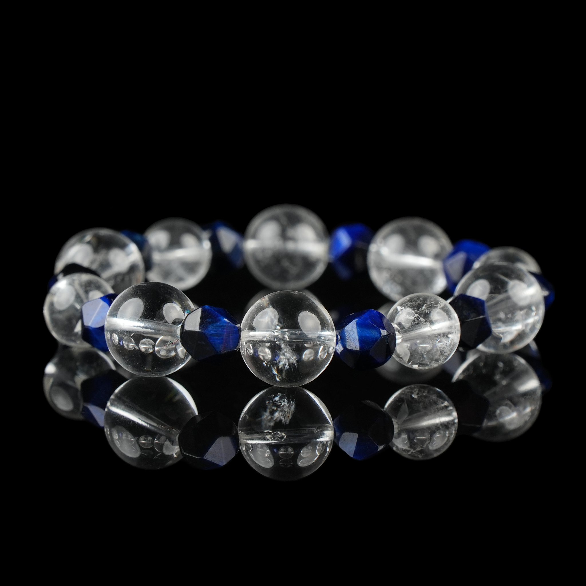 Clear Quartz and Blue Faceted Bead Crystal Bracelet – Energy Amplifying Healing Stone Jewelry on Black Background.