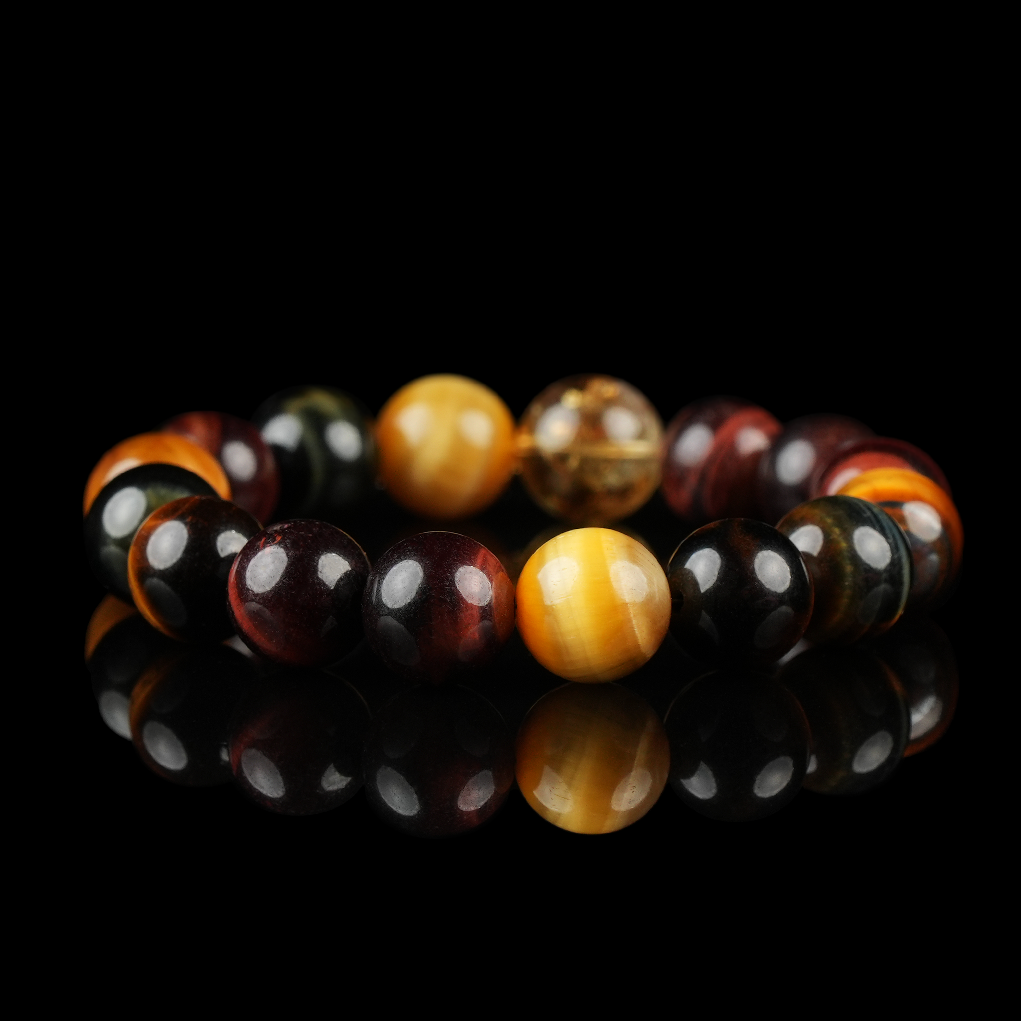 Tiger Eye Stone Bracelet with Golden, Red, and Blue Beads – Natural Energy Crystal Jewelry for Confidence and Grounding on Black Background.