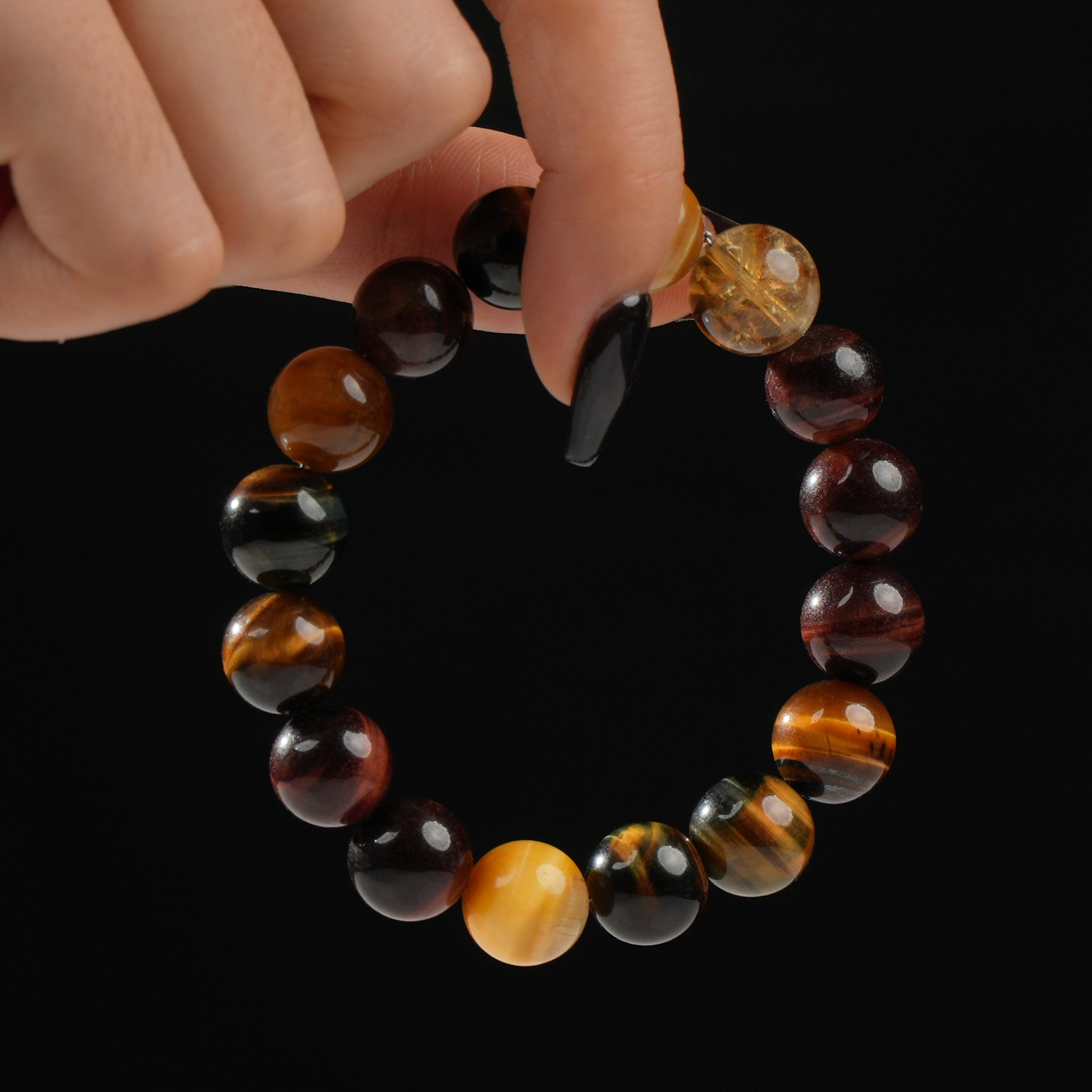 Beaded bracelet with mixed tiger’s eye stones and citrine for confidence and energy.