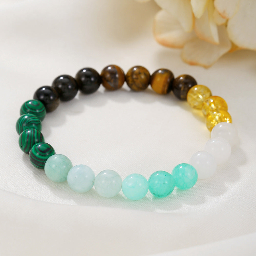 A multistone beaded bracelet laid on a white cloth background, showing full color symmetry and crystal variety.