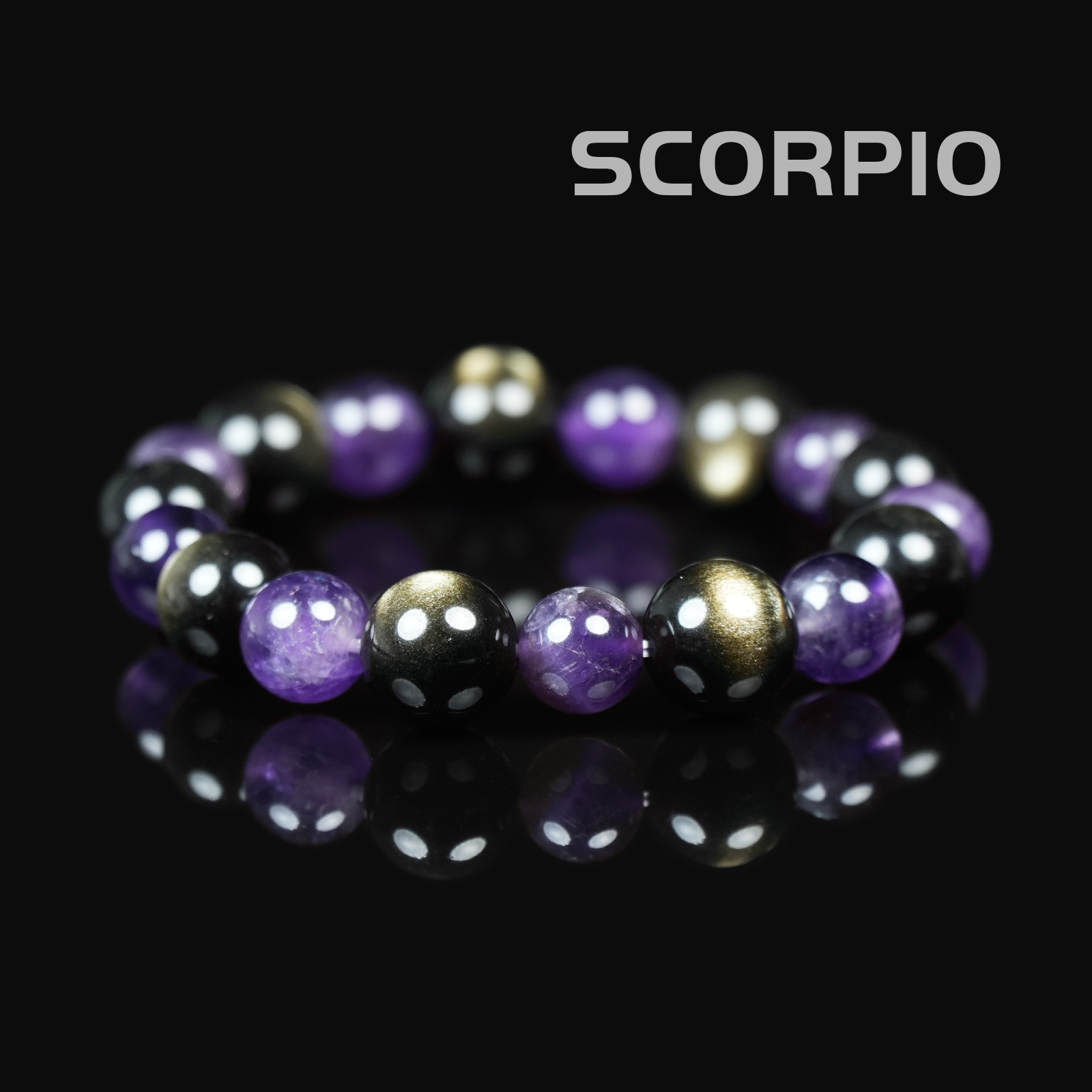 Flat lay of Scorpio zodiac bracelet featuring deep purple amethyst, metallic hematite, and gold-toned pyrite on a black reflective surface.