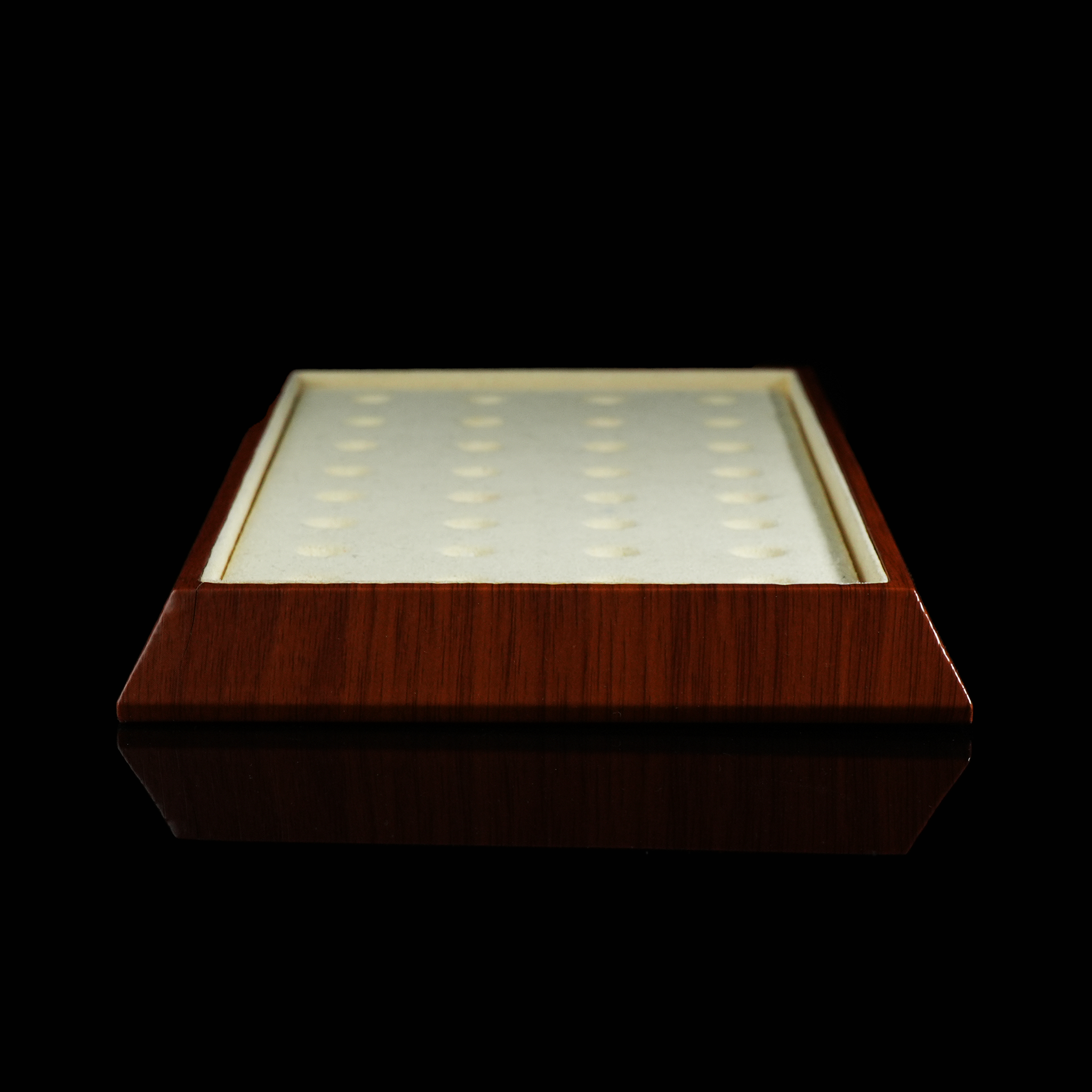 A side view showcasing the thickness of the wooden frame and the low-profile velvet inlay. The evenly spaced indentations are clearly visible, offering practical storage for beads or small stones.