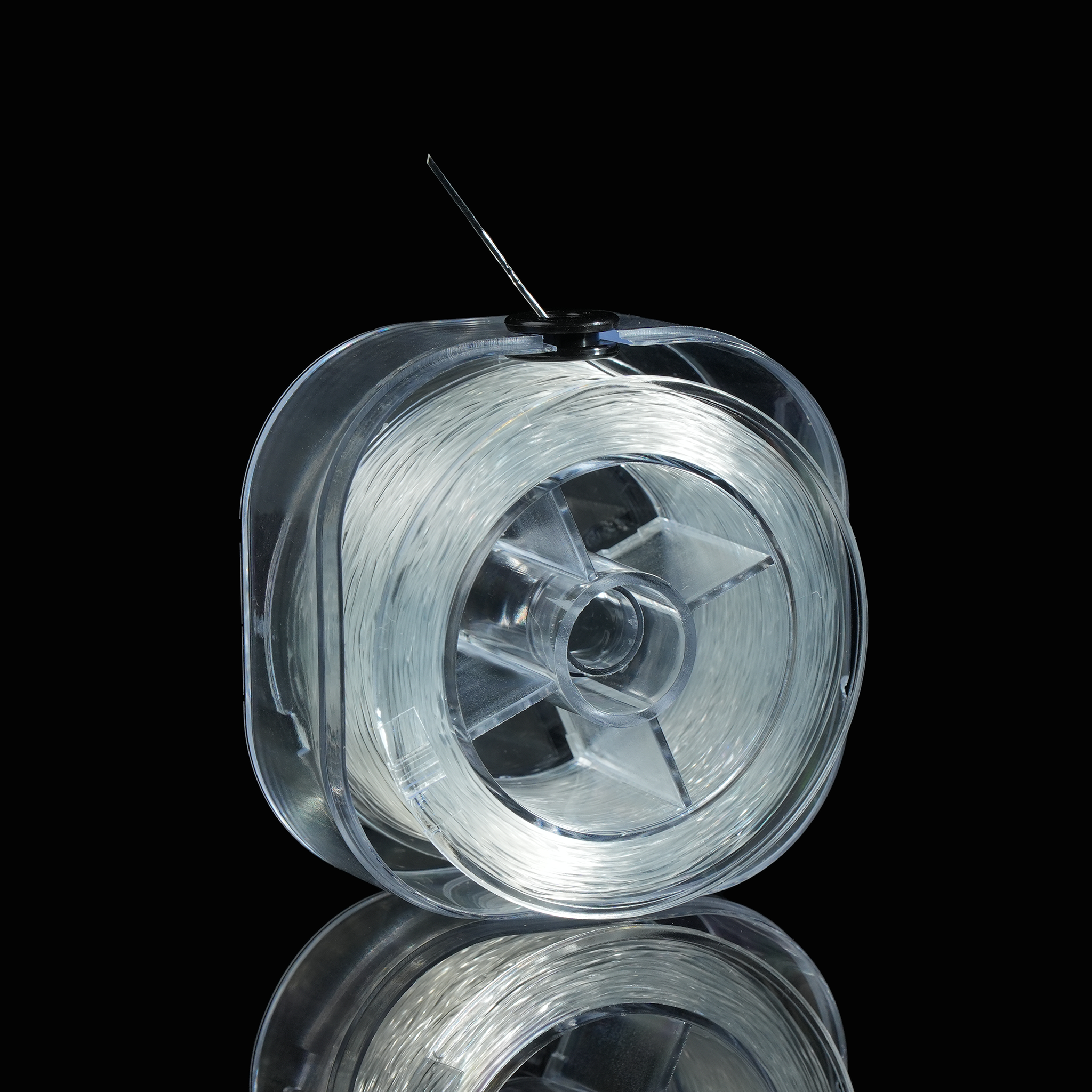 A side profile showing the thickness of the spool and how the elastic thread feeds out from the center. The thread appears durable yet flexible, ideal for jewelry making.