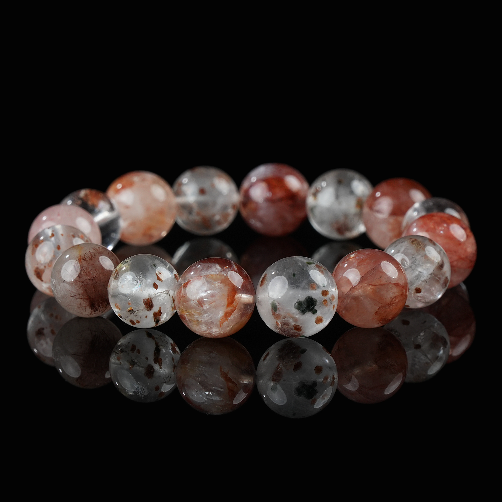 Strawberry galaxy quartz bracelet with clear and pink-red beads on black background, ideal for self-love and healing energy.