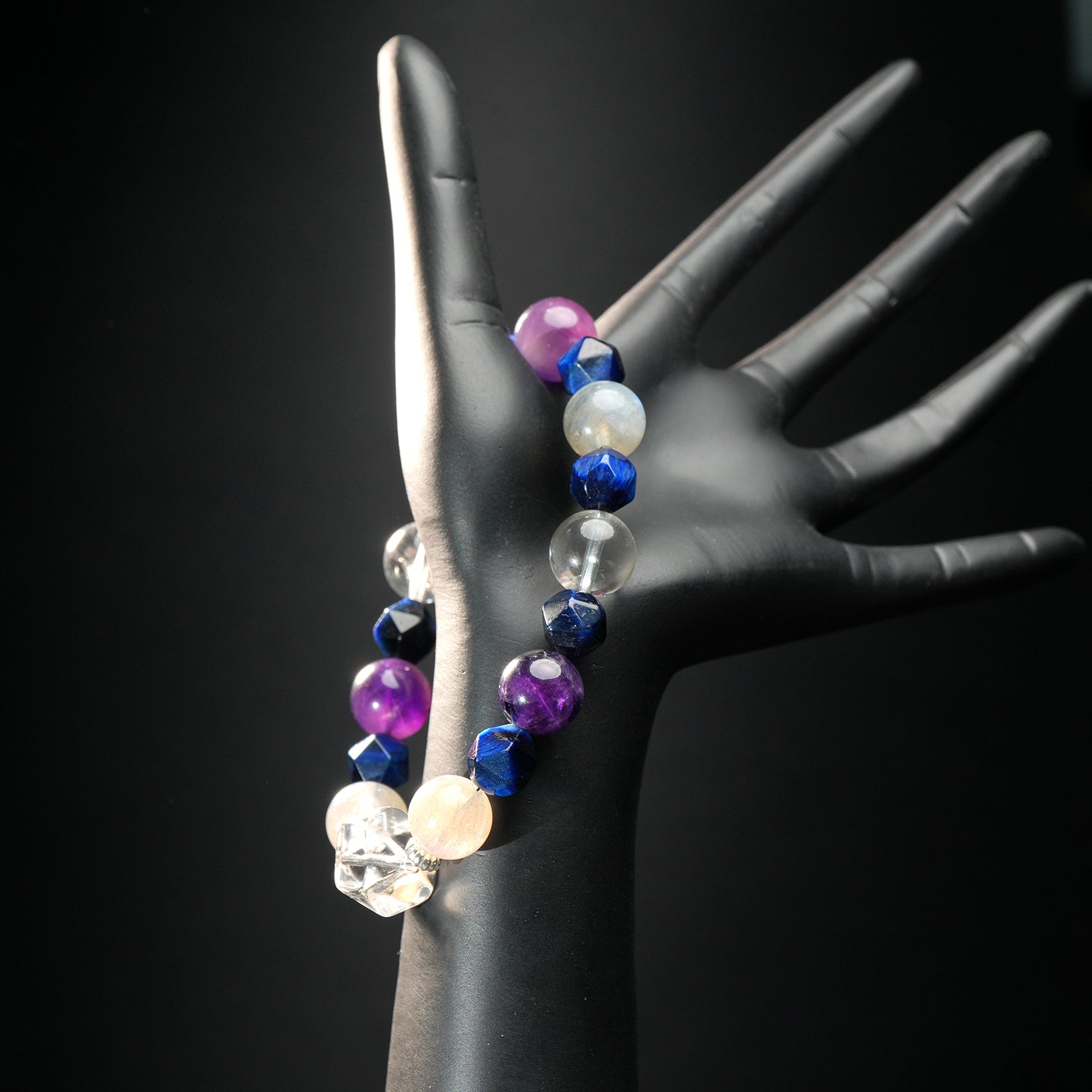 Aquarius astrology bracelet worn on mannequin hand, made with amethyst, labradorite, and quartz beads for balance and intuition.