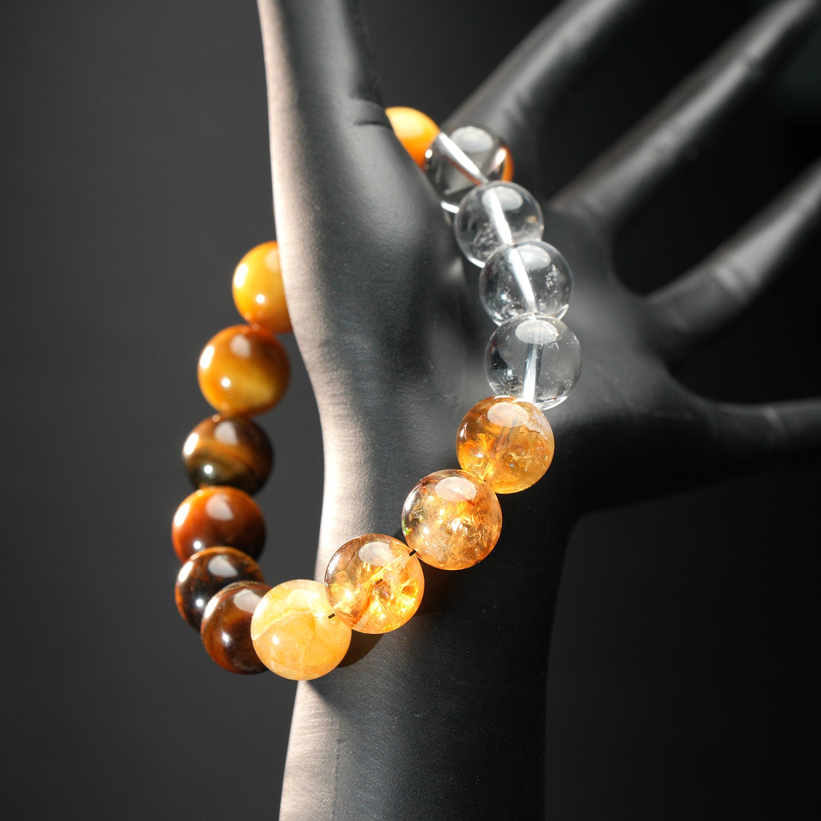 Leo astrology bracelet displayed on mannequin hand, featuring radiant citrine, golden tiger eye, and clear quartz for confidence and energy.