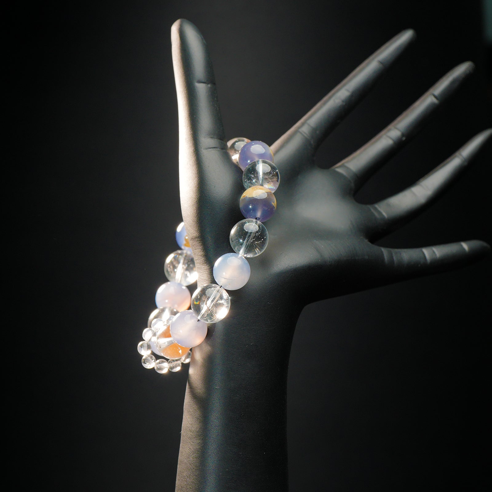 Libra astrology bracelet displayed on a mannequin hand, featuring calming blue chalcedony and clear quartz for emotional balance and harmony.