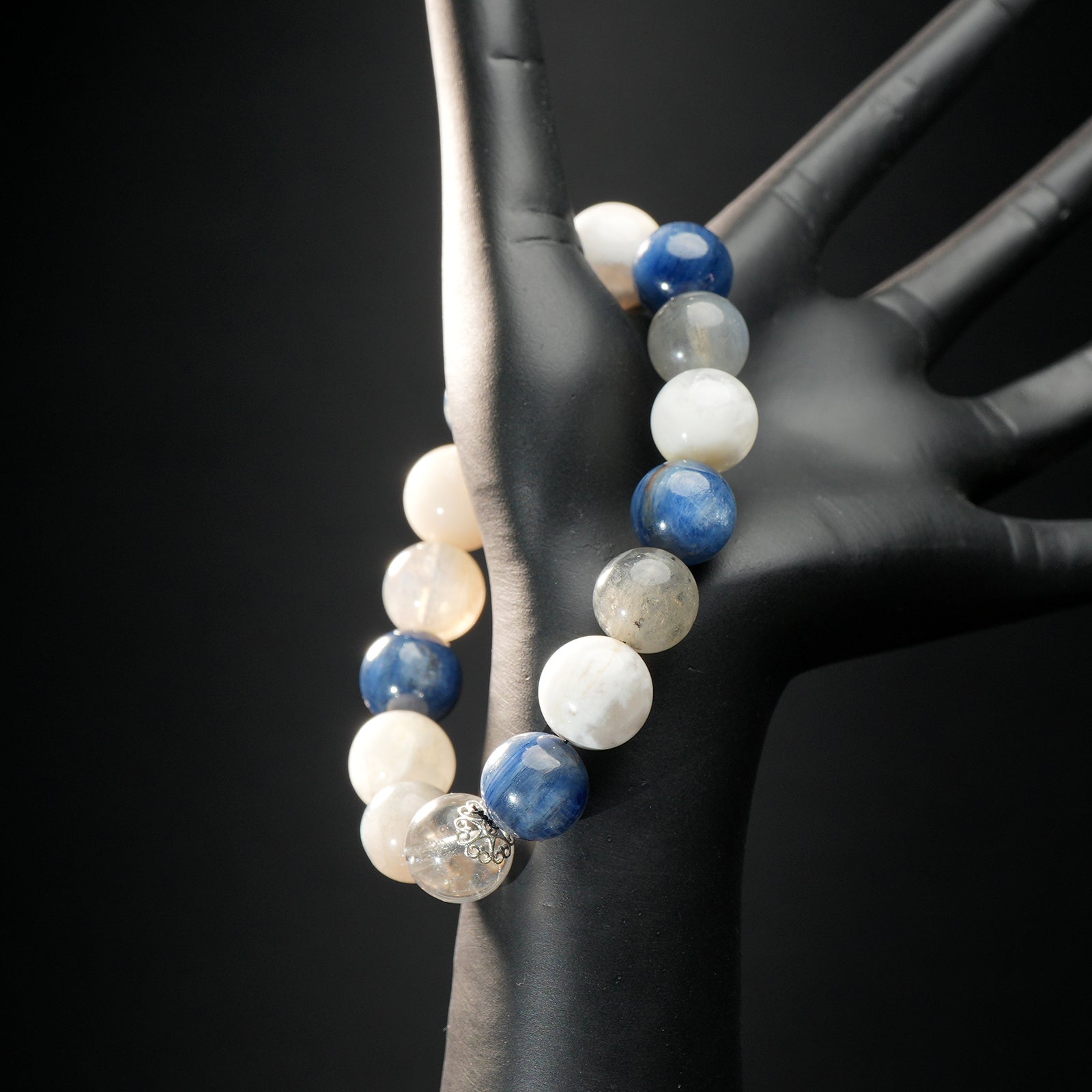 Pisces zodiac bracelet displayed on a mannequin hand, featuring blue kyanite, white moonstone, and clear quartz healing beads.