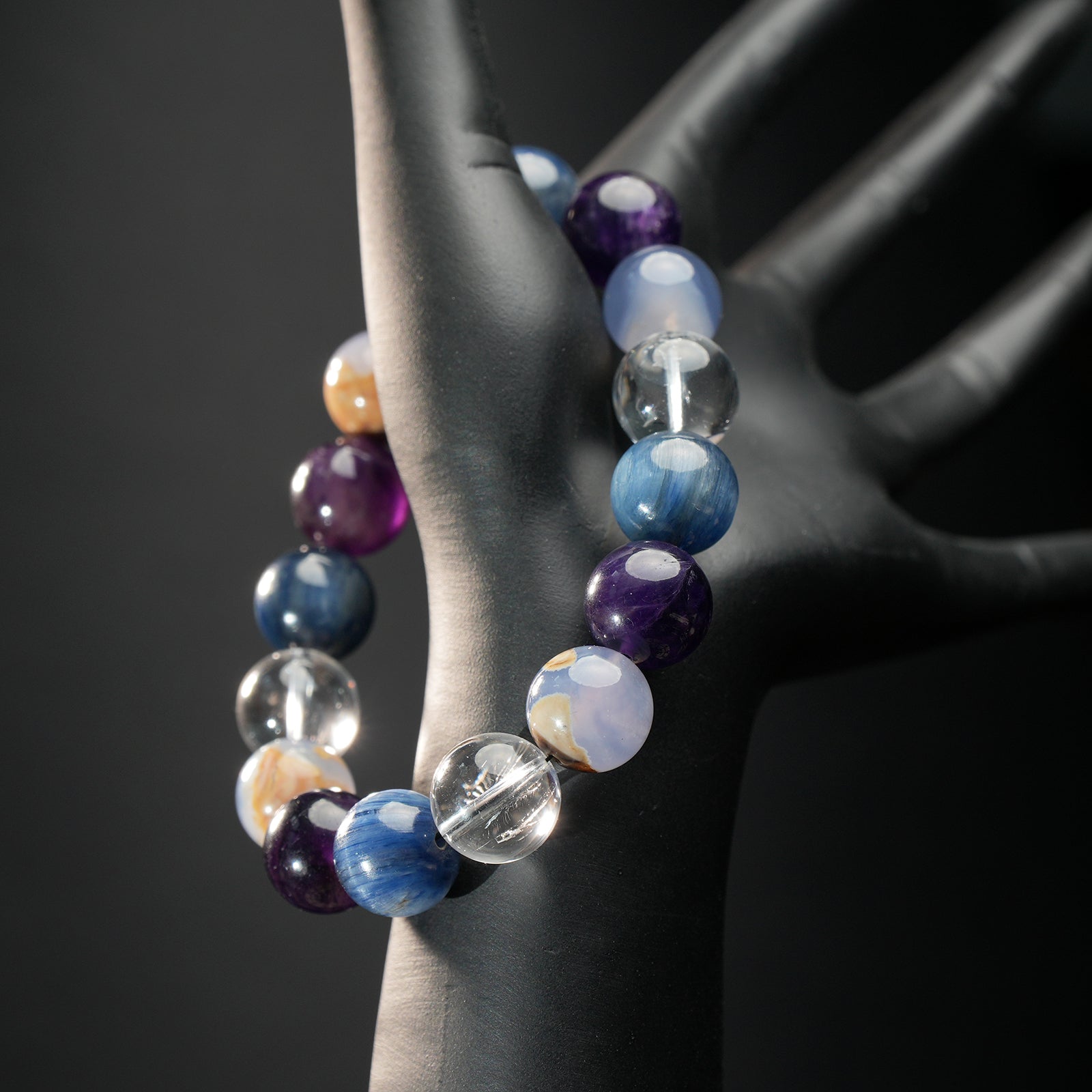 Virgo astrology bracelet worn on black mannequin hand, featuring a mix of purple amethyst, blue kyanite, and white chalcedony for mental clarity.