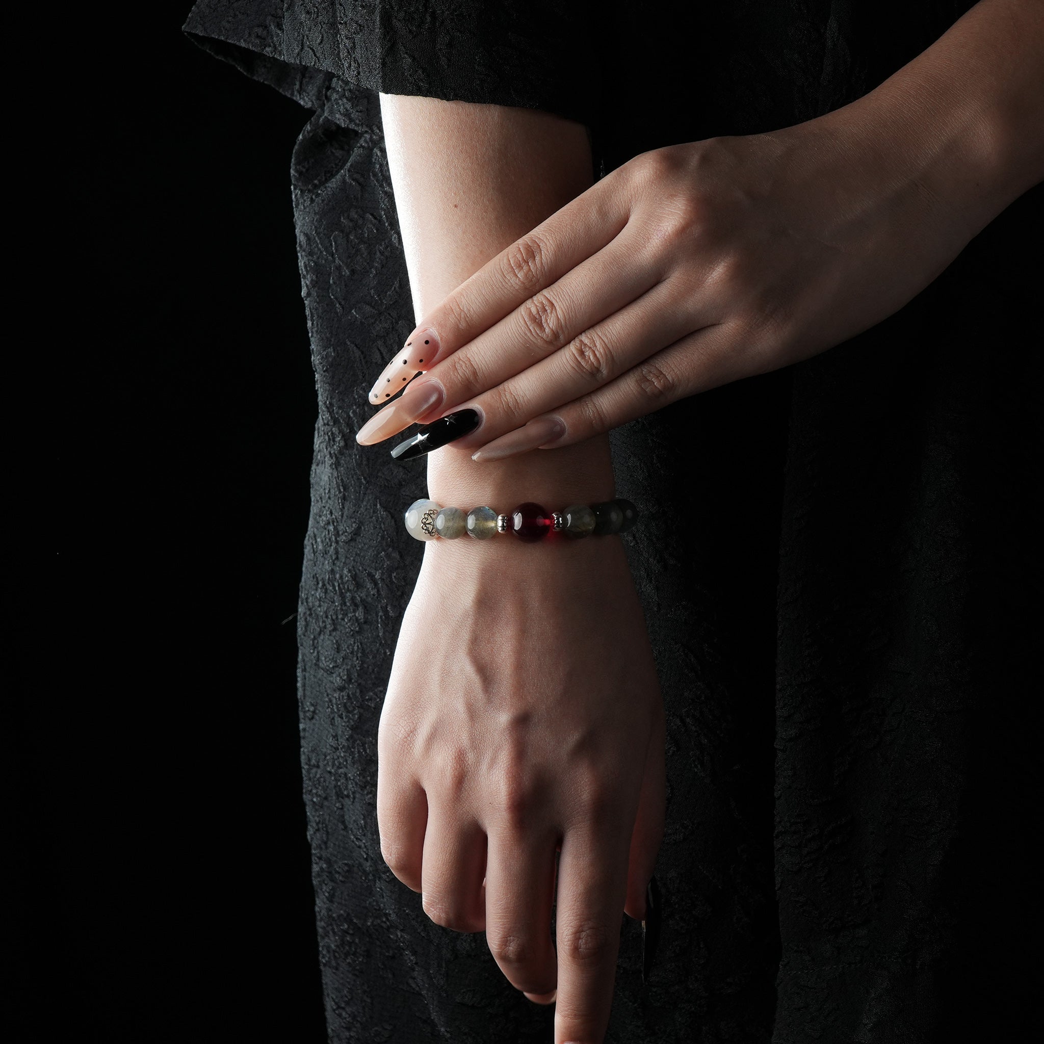 A model elegantly wears a Grey Moonstone and Red Garnet bracelet, combining soft moonlight tones with the bold energy of garnet for a refined and balanced look.