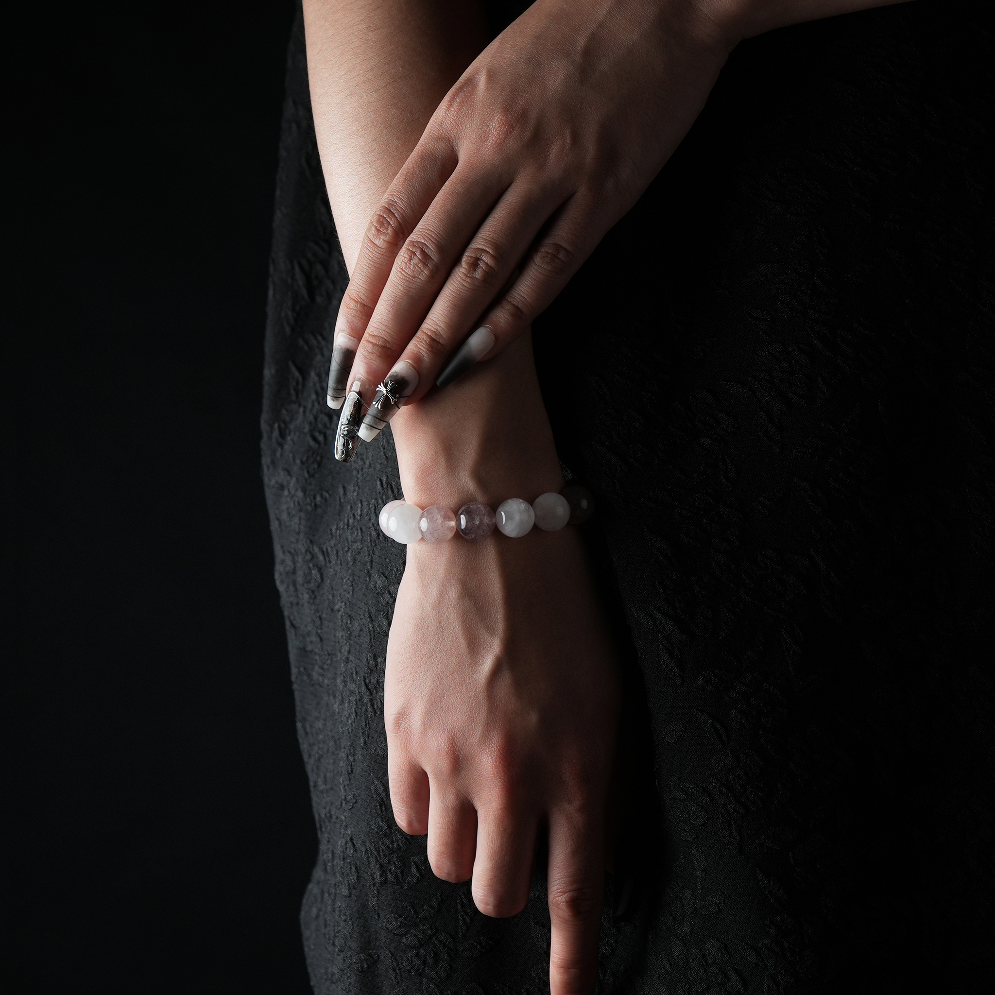 Rose Quartz and Strawberry Quartz crystal bracelet on female wrist, natural gemstone jewelry for love and healing.