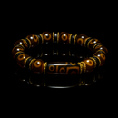 The bracelet rests on a glossy black reflective surface, creating a dramatic and luxurious presentation. The warm brown tones of the beads and the gold accents shine under the lighting, while the central Dzi bead reflects below, reinforcing its spiritual and visual prominence. The image gives a premium, gallery-like aesthetic perfect for luxury product showcases.