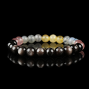 Bracelet featuring natural silver sheen obsidian, grey moonstone, strawberry quartz, and citrine beads on a reflective black surface.
