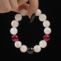 This handmade bracelet showcases the misty elegance of Snow Phantom Quartz, paired with vibrant Red Garnet and grounded by a deep black Obsidian centerpiece. A refined combination symbolizing clarity, vitality, and protection.