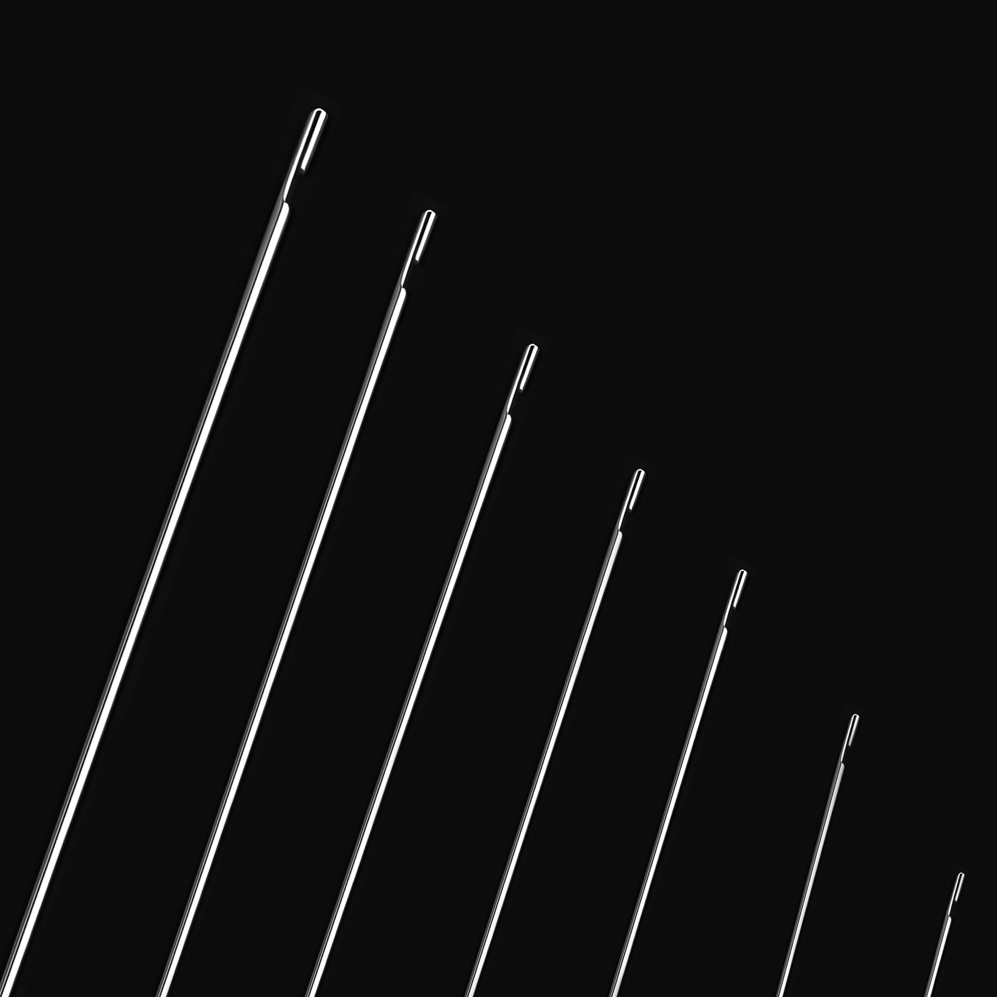 A diagonal view of multiple beading needles arranged side by side, showcasing their consistent length and fine tips—ideal for precise beadwork.