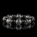 A minimalist crystal bracelet crafted from snow phantom quartz, clear quartz, and polished black obsidian beads. The contrast of clarity and darkness symbolizes balance, grounding, and intuitive strength—ideal for spiritual protection and focused energy.
