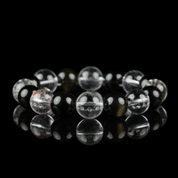 A minimalist crystal bracelet crafted from snow phantom quartz, clear quartz, and polished black obsidian beads. The contrast of clarity and darkness symbolizes balance, grounding, and intuitive strength—ideal for spiritual protection and focused energy.