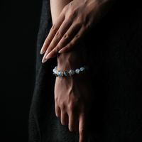 Elegant opalite butterfly bracelet shown on hand, infused with calming energy and spiritual focus, perfect for crystal healing enthusiasts.