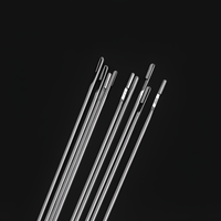 A zoomed-in shot of the needle heads, focusing on the different sizes and shapes of the eyes. The craftsmanship and polished finish of the stainless steel material are clearly visible.