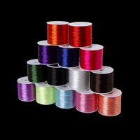 An assortment of flat elastic thread spools arranged in rows, featuring a wide variety of vibrant colors. Ideal for customized or themed jewelry projects.