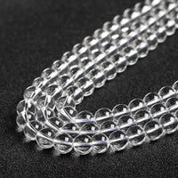 Glossy, polished white crystal beads lined up closely for display.
