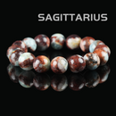 Flat lay of Sagittarius zodiac bracelet made with natural red jasper and blue-green amazonite gemstone beads on black background.