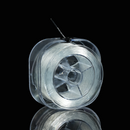 A side profile showing the thickness of the spool and how the elastic thread feeds out from the center. The thread appears durable yet flexible, ideal for jewelry making.