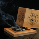 Sage smoldering inside celestial-engraved bamboo cube, smoke drifting upward dramatically.