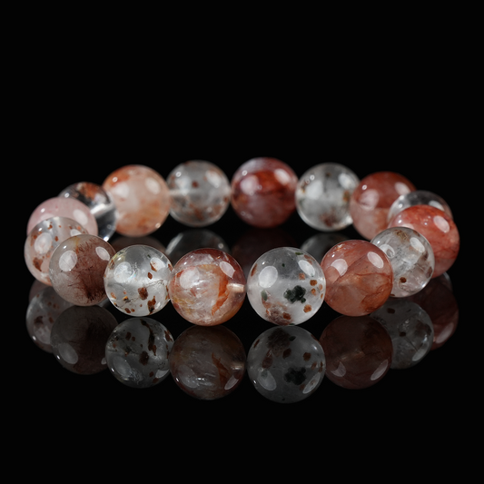 Strawberry galaxy quartz bracelet with clear and pink-red beads on black background, ideal for self-love and healing energy.