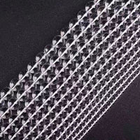 High-grade crystal bead strands in neat rows, reflecting subtle light patterns.