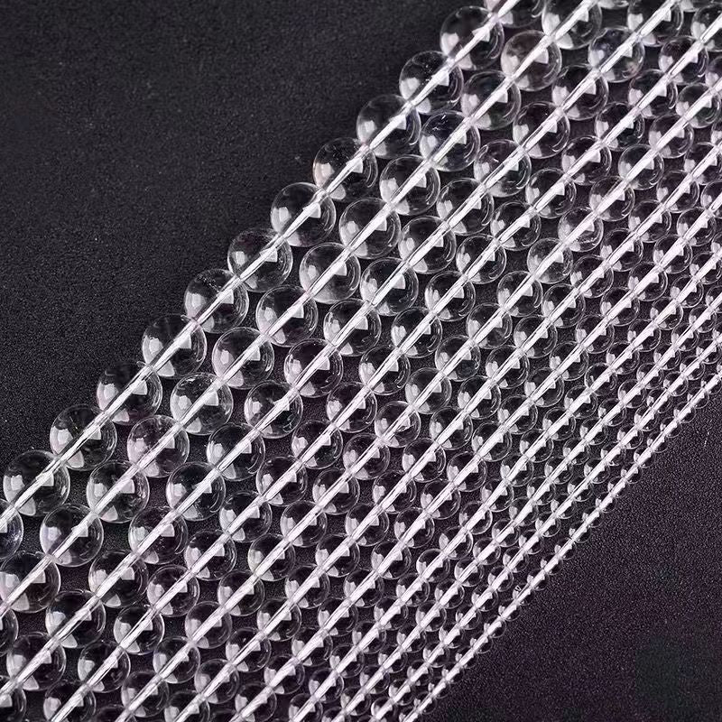 High-grade crystal bead strands in neat rows, reflecting subtle light patterns.