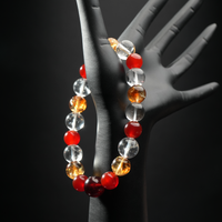 Aries crystal healing bracelet worn on hand mannequin, made with red agate, yellow citrine, and clear quartz – birthstone bracelet for Aries.