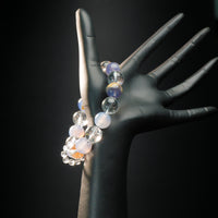 Libra astrology bracelet displayed on a mannequin hand, featuring calming blue chalcedony and clear quartz for emotional balance and harmony.