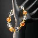 Taurus astrology bracelet worn on a mannequin hand, made with golden yellow citrine, clear quartz, and golden rutilated stones for abundance and grounding.