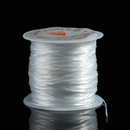 This image features a spool of white flat elastic thread tightly wound and ready for use. The thread has a smooth, slightly glossy surface, ideal for jewelry making or crafting projects that require strength and flexibility.