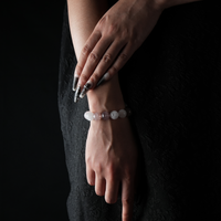 Rose Quartz and Strawberry Quartz crystal bracelet on female wrist, natural gemstone jewelry for love and healing.