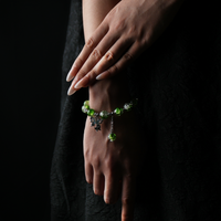 A refreshing green energy bead bracelet worn on the wrist, its translucent texture reflects light like a forest breeze, with a butterfly charm that adds a touch of spirit and vitality.
